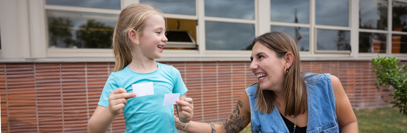 Teacher and student laughing together